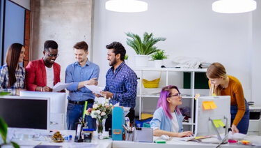 Diverse team of professionals collaborating in a modern office workspace